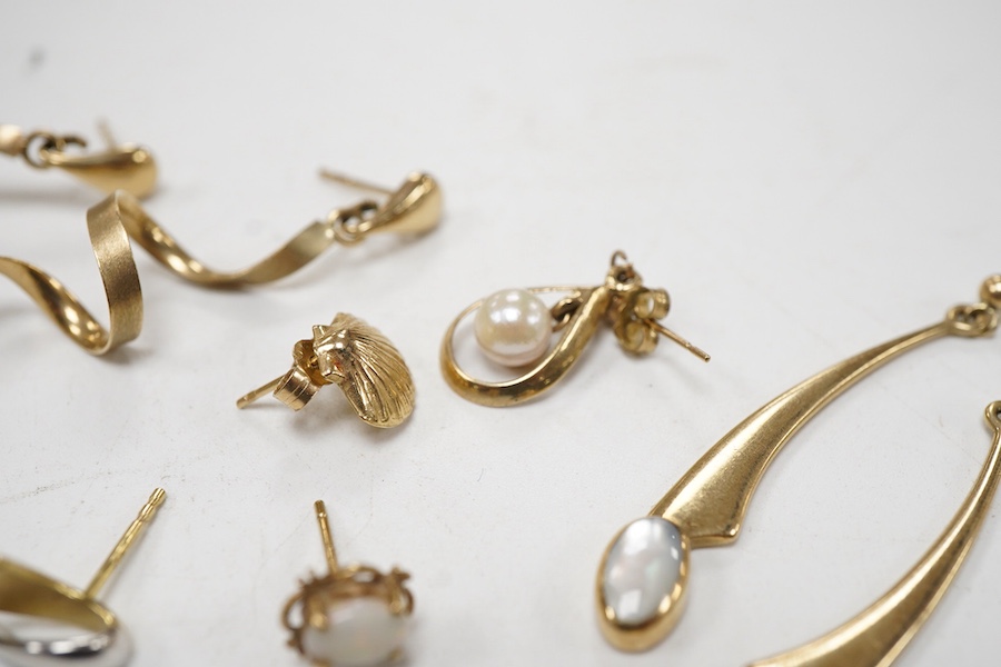 Three modern pairs of 9ct gold earrings, including spiral, triangular and moonstone set, together with five odd earrings.